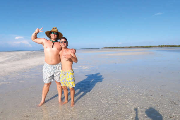Two young men on the beach during a Florida Keys sandbar tour.